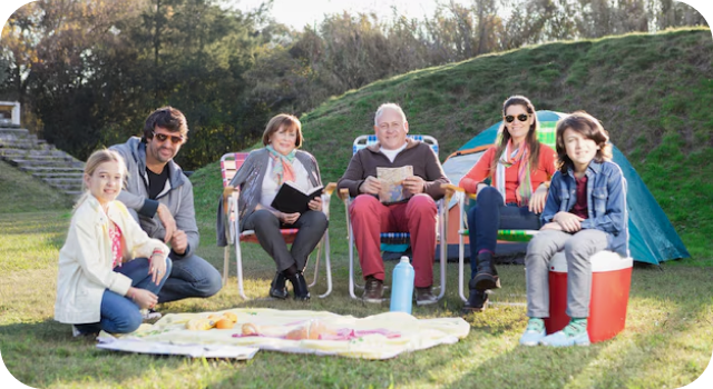 Group of friends sitting on a blanket in a park